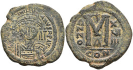 Justinian I Æ 40 Nummi. Constantinopolis, Year 17 = 543/44.Helmeted and cuirassed facing bust, holding globus cruciger and shield; cross to right / La...