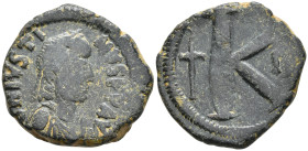 Justin I. Æ Half Follis AD 518-527. Constantinople mint, 3rd officina. Diademed, draped, and cuirassed bust right / Large K; long cross to left, below...