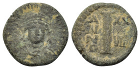 Justinian I (527-565). Æ 10 Nummi. Catania(?), dated RY 29 (AD 556/7). Helmeted and cuirassed bust facing, holding globus cruciger and shield. R/ Larg...