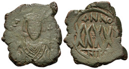Phocas (602-610). Æ 40 Nummi (28mm, 11.6g). Nicomedia, year 4? (605/6). Crowned bust facing, wearing consular robes, holding mappa and cross; crown wi...