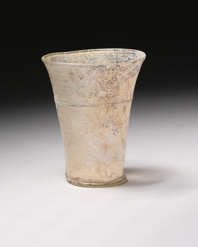 **Item Description**

A stunning ancient Roman pale yellow glass beaker with a b...