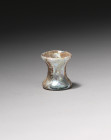 **Item Description:**

**Title:** Roman Glass Candlestick Bottle

**Era:** Roman, 2nd Century CE

**Medium:** Glass

**Dimensions:** H: 2.2 cm

**Desc...