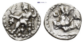 Lycaonia, Laranda, c. 324/3 BC. AR Obol (10mm, 0.65 g). Baaltars seated l., holding grain ear, grape bunch, and sceptre. R/ Forepart of wolf r.; inver...