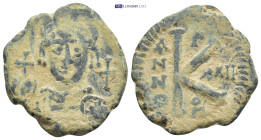 Justinian I Æ 20 Nummi.Theoupolis (Antioch) (10.25 Gr. 26m)
Helmeted and cuirassed bust facing, holding globus cruciger and shield; cross in right fie...