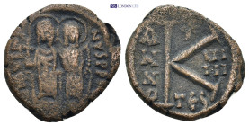 Justin II and Sophia (565-578). Æ 20 Nummi (20mm, 5.37 g). Nimbate figures of Justin and Sophia seated facing on double throne, holding globus crucige...