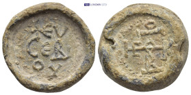 Byzantine Lead Seal (24mm, 22.8 g) Obv: Legends in three lines. Rev: Cruciform monogram.