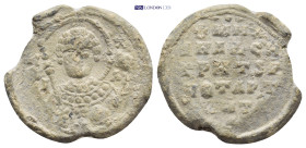Byzantine Lead Seal (22mm, 7.14 g) Obv: Nimbate facing bust of Saint, holding spear over his right shoulder and resting shield on his left arm. Rev: L...
