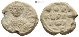 Byzantine Lead Seal (20mm, 7.13 g) Obv: Nimbate facing bust of Saint, holding spear over his right shoulder and resting shield on his left arm. Rev: L...