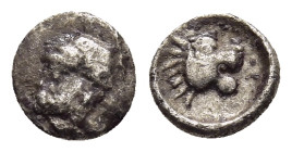 ACHAEMENID EMPIRE. Tetartemorion (early- mid 4th century BC). Uncertain mint in Cilicia.

Obv: Bearded and helmeted head left.
Rev: Head of lion right...