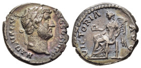 HADRIAN (117-138). Denarius. Rome.

Obv: HADRIANVS AVG COS III P P.
Bare head right.
Rev: VICTORIA AVG.
Victory seated left on throne, holding wreath ...