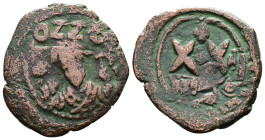 Phocas, 602-610 AD. AE Half Follis (24mm, 5,55g.) Overstruck Half Follis of Phocas, his Consular frontal bust holding globe surmounted with cross and ...