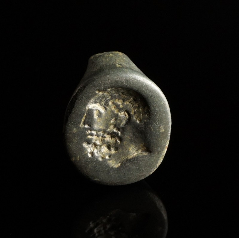 Greek Bronze Signet Ring
3rd-1st century BCE
Bronze, 22 mm
Showing a bearded ...