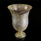Roman Glass Cup
2nd-3rd century CE
White Glass, 103 mm
Intact. Cup with stemmed base. 
Very fine condition. Sintered surface. Small cracks and spa...