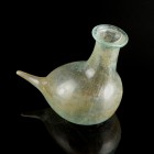 Roman Glass Dropping-Bottle
1st-2nd century CE
Greenish Glass, 98 mm
Intact. 
Very fine condition. 
Ex. Coll. B.K., acquired at the european art ...