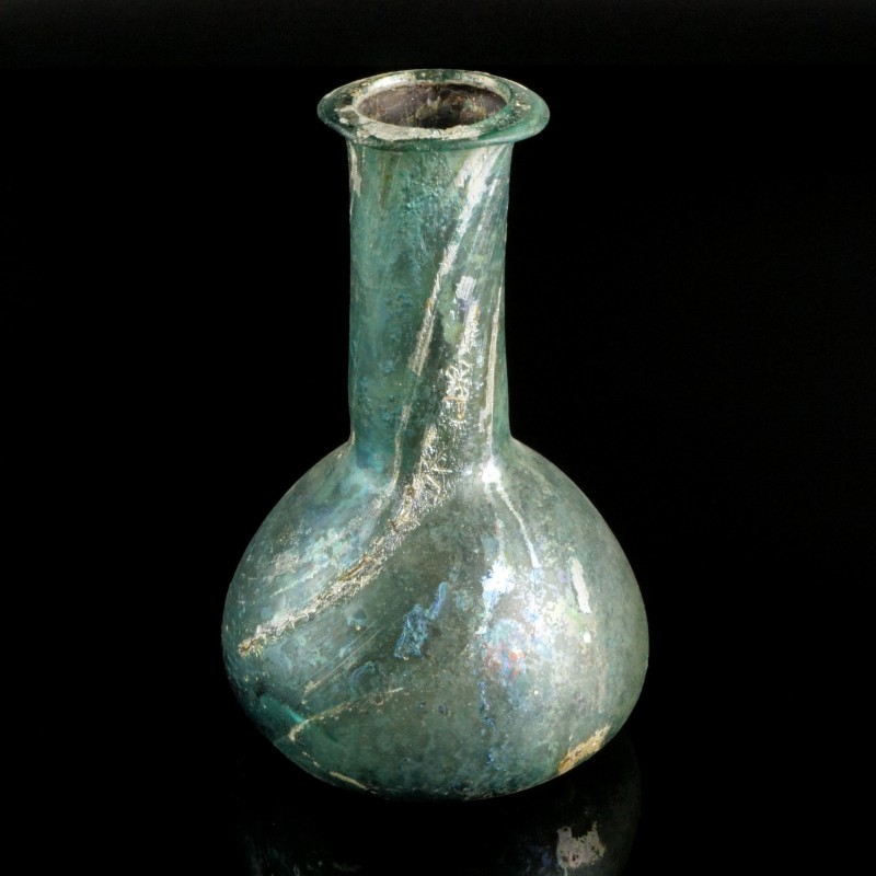Roman Glass Bottle
1st-3rd century CE
Greenish-Blue Glass, 122 mm
Intact. 
V...