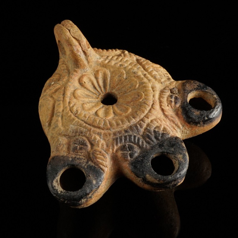 Roman Oil Lamp
2nd-4th century CE
Clay, 89 mm
Richly decorated. Three spouts....
