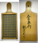 JAPAN: wooden money counter, 128 x 309mm, with the front divided into 80 cubicles (each 12 x 18mm), kin go ryo ("gold 5 ryo") and the name Nabeya Tomo...
