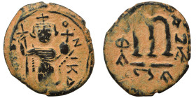 Arab Byzantine. Umayyad Caliphate, circa 641-660 AD. Fals (bronze, 3.43 g, 22 mm). Pseudo-Byzantine type, imitating the types of Constans II. Standing...