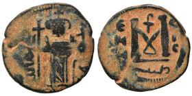 Arab Byzantine. Umayyad Caliphate, circa 641-660 AD. Fals (bronze, 3.75 g, 22 mm). Pseudo-Byzantine type, imitating the types of Constans II. Standing...