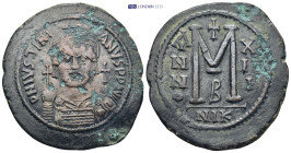 Justinian I, 527-565.AE Follis Nicomedia 25 Gr. 43mm.
 Helmeted and cuirassed bust of Justinian facing, holding globus cruciger in his right hand and ...