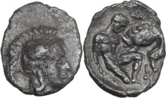Greek Italy. Southern Apulia, Tarentum. AR Diobol, 325-280 BC. Obv. Head of Athena right, wearing helmet decorated with Scylla. Rev. Herakles kneeling...