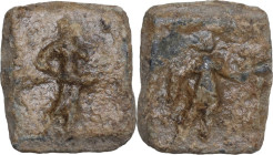 The Roman Empire. PB rectangular Tessera, 1st century BC-1st century AD. D/ Figure (Priapus?) advancing right, cloak hanging from right arm, holding u...