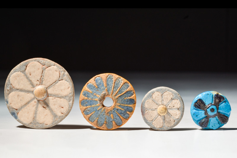 FOUR EGYPTIAN ROSETTE INLAYS

 New Kingdom, 20th Dynasty, Ca. 1186 - 1069 BC
...