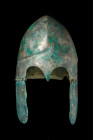 GREEK BRONZE CHALCIDIAN HELMET

 Ca. 500-300 BC
 A bronze helmet forged in one piece, featuring high-arched eyebrows with a nose guard and a flarin...