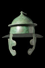 ROMAN BRONZE WEISENAU HELMET OF ITALIC TYPE

 Ca. AD 100-200
 A bronze helmet with a round skull, topped with a small mushroom-shaped knob (peak) a...