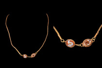 RARE ROMAN GOLD NECKLACE WITH AVIAN CAMEO CLASP

 Ca. AD 1-300
 A sophisticated gold necklace with a loop-in-loop strand, rope-like in appearance, ...