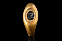 ROMAN GOLD RING WITH BANDED AGATE INTAGLIO OF FAUNUS

 Ca. AD 200
 A gold finger ring comprised of a round shallow hoop with expanded shoulders and...