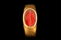 ROMAN GOLD RING WITH CERES CARNELIAN INTAGLIO

 Ca. AD 100-200
 A gold finger ring composed of a broad, flat-section hoop, culminating in a bezel s...