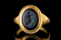 ROMAN NICOLO INTAGLIO WITH MARS IN GOLD RING

 Ca. 1st century AD
 A nicolo intaglio depicting the god Mars (Greek Ares). The god is depicted turne...