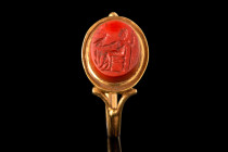 ROMAN RED JASPER INTAGLIO WITH ZEUS SITTING ON A THRONE IN NEOCLASSICAL GOLD RING

 Ca. 2nd century AD (intaglio); Ca. late 18th century AD (ring)
...