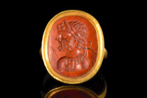 ROMAN GOLD RING WITH RED JASPER INTAGLIO OF CARACALLA

 Ca. 3rd century AD
 A gold finger ring with a circular hoop and large oval-shaped bezel, se...