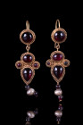 MATCHED PAIR OF ROMAN GOLD EARRINGS WITH GARNETS AND PEARLS

 Ca. AD 300-400
 A matched pair of gold earrings, each composed of a gold loop and a c...