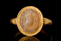 ROMAN JASPER OR AGATE INTAGLIO WITH GOD NEAR AN ALTAR IN GOLD RING 

 Ca. AD 1-200
 A large, oval-shaped jasper or agate intaglio depicting a nude ...