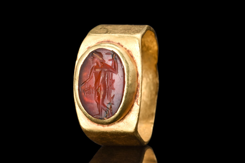 ROMAN GOLD RING WITH GENIUS CARNELIAN INTAGLIO 

 Ca. AD 300
 A gold ring ado...