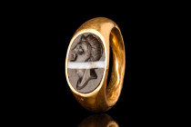 ROMAN GOLD RING WITH BANDED AGATE PORTRAIT INTAGLIO 

 Republican, Ca. 100 BC - AD 100
 A gold finger ring with expanding shoulders and a large ova...