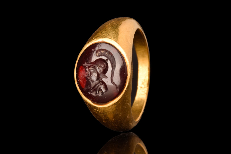 ROMAN GOLD RING WITH MINERVA INTAGLIO

 Ca. AD 100-300
 A gold finger ring of...