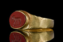 A ROMAN GOLD AND CARNELIAN INTAGLIO RING DEPICTING AN ELEPHANT

 Ca. 100 BC - AD 100
 A gold finger ring of a flat-section hoop with a red jasper i...