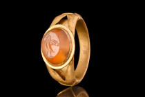 ROMAN CARNELIAN INTAGLIO OF A GOOSE IN GOLD RING

 Ca. AD 100-200
 A gold finger ring adorned with a convex carnelian intaglio engraved with a prof...