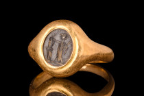 ROMAN INTAGLIO WITH MINERVA IN GOLD RING

 Ca. AD 100-200
 A rounded black stone intaglio boasting an engraved left-facing depiction of the goddess...