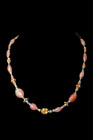 ROMAN GOLD AND STONE NECKLACE

 Ca. AD 1-300
 A restrung necklace formed of large, red stone beads which are interspersed with arrangements of blue...