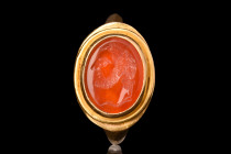 ROMAN CARNELIAN INTAGLIO OF ANTONINUS PIUS IN GOLD RING

 Ca. 2nd Century AD
 An oval-shaped carnelian intaglio featuring a left-facing portrait of...