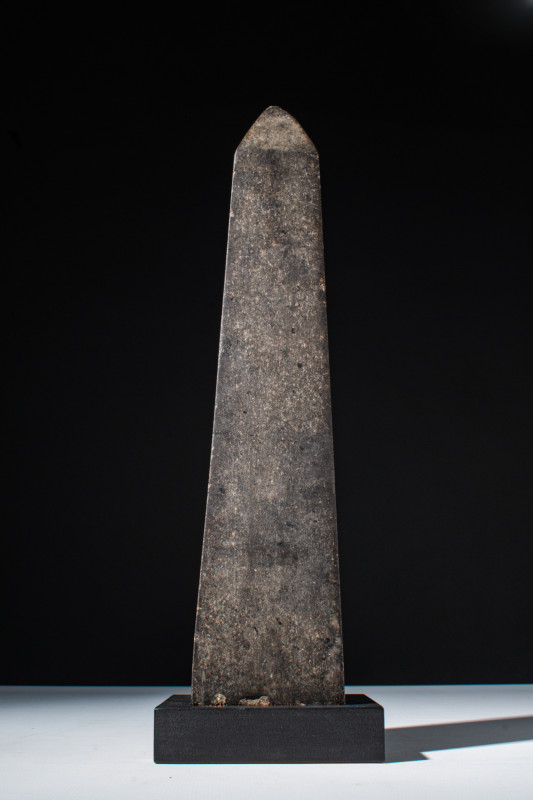 EGYPTIAN BROWN STONE VOTIVE MODEL OF OBELISK 

 New Kingdom, Ca. 1550 - 1070 B...