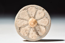 EGYPTIAN FAIENCE ROSETTE INLAY

 New Kingdom, 20th Dynasty, Ca. 1184 - 1153 BC
 A glazed faience rosette set with creamy brown petals on a brown ba...