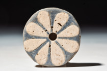 EGYPTIAN FAIENCE ROSETTE INLAY

 New Kingdom, 20th Dynasty, Ca. 1184 - 1153 BC
 A glazed faience rosette set with creamy brown petals on a blue or ...