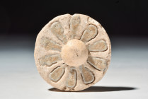 EGYPTIAN FAIENCE ROSETTE INLAY

 New Kingdom, 20th Dynasty, Ca. 1186 - 1069 BC
 A glazed faience inlay in the form of a rosette, set with an eight-...