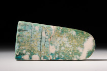 EGYPTIAN FAIENCE INLAY

 Late Dynastic Period, Ca. 664-332 BC
 A tongue shaped faience inlay with hatched decoration in six panels, possibly a deco...